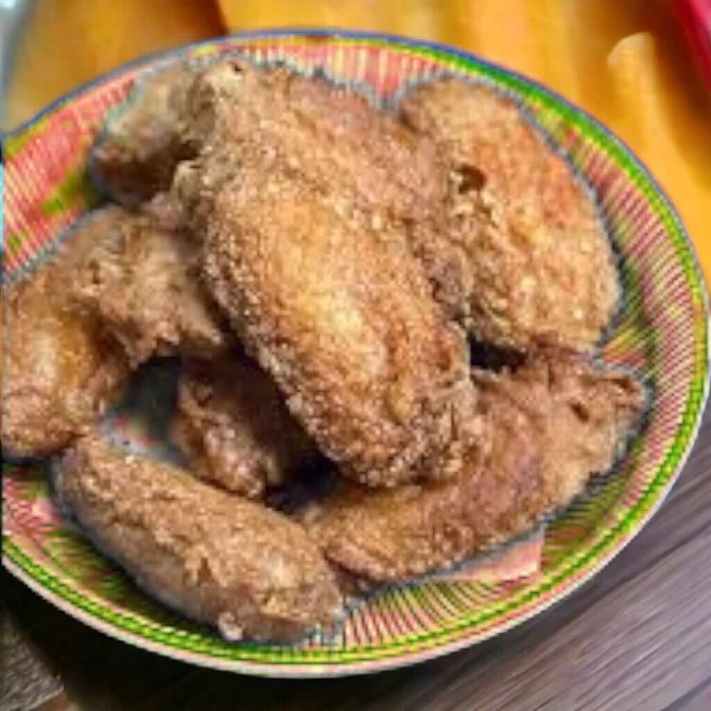 Mouth-watering fried chicken wings on a plate, seasoned with prawn paste