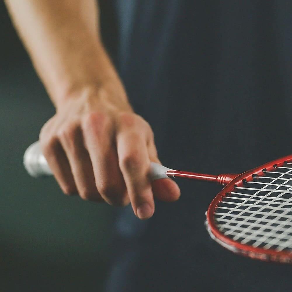 Image of a person with a red badminton racket