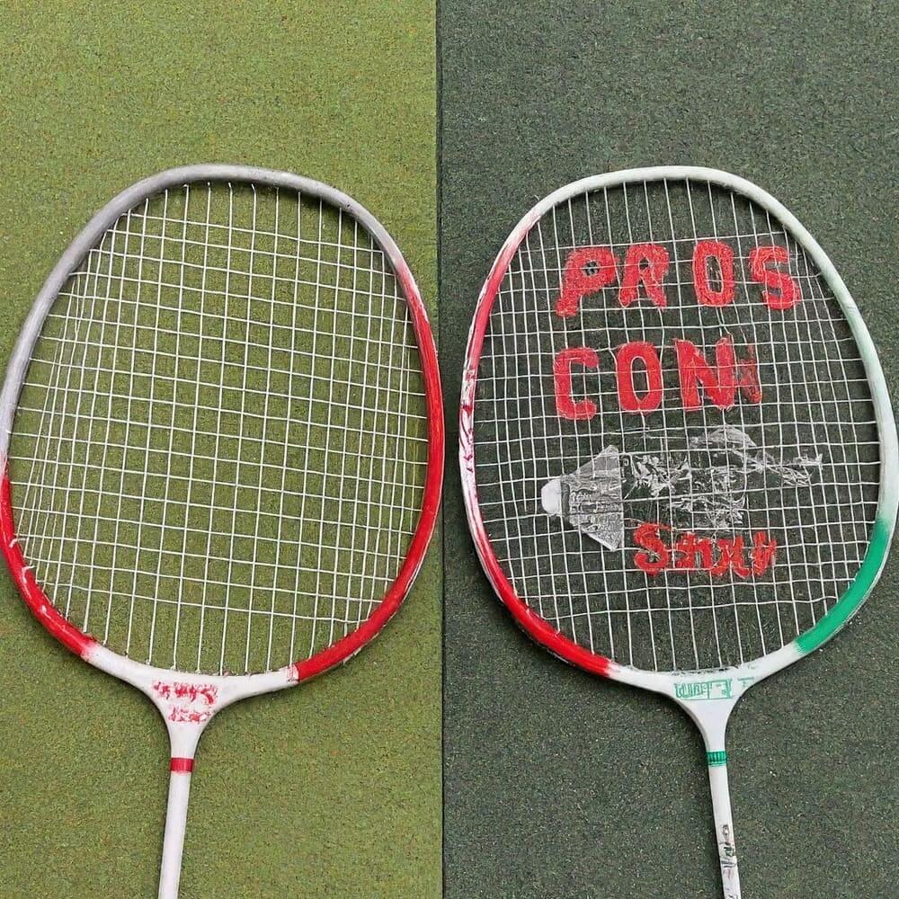Two badminton rackets with 'pro's and con's' written on them, showcasing equipment for the sport